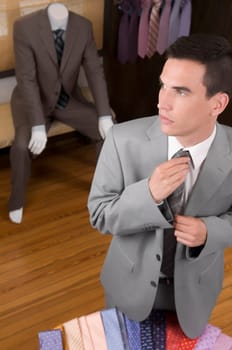 Businessman selecting a tie in a clothing store