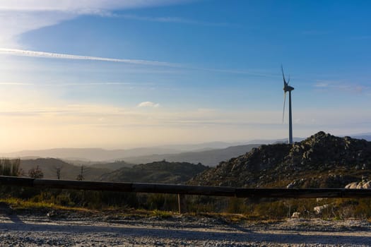 Wind energy turbines, in a landscpae over a beautiful blue sky