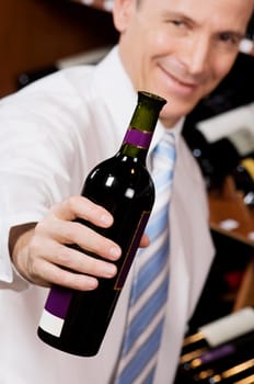 Businessman showing a wine bottle