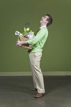 Businessman holding his belongings and smiling