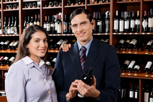 Businessman with a businesswoman holding a wine bottle