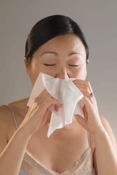 Close_up of a woman sneezing