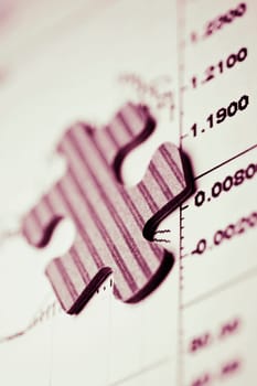 Close_up of a jigsaw piece on a chart