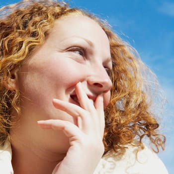 Close_up of a young woman smiling and looking away