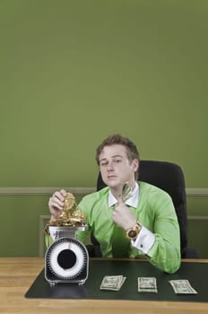 Businessman holding currency notes and weighing gold jewelry