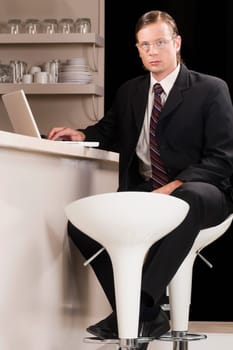 Businessman working on a laptop in a bar