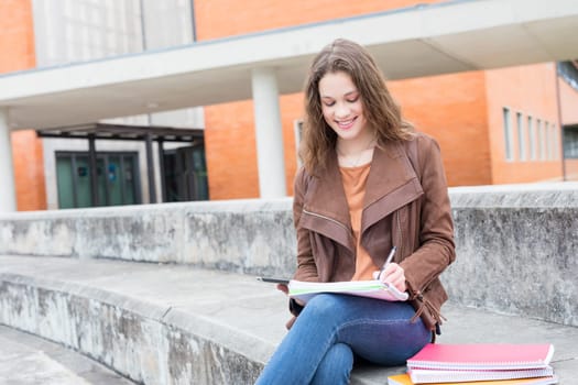 Happy young student at the university campus