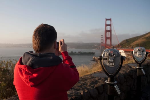 Tourist taking the picture of a bridge, Golden Gate Bridge, San Francisco Bay, San Francisco, California, USA