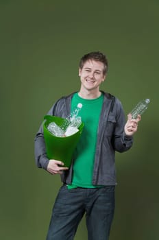 Portrait of a man holding a recycling bin and smiling