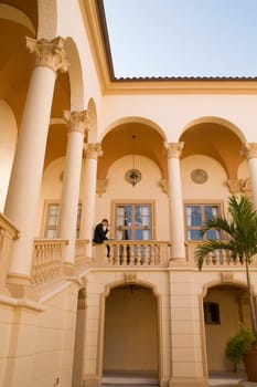 Businessman working on a laptop in the balcony, Biltmore Hotel, Coral Gables, Florida, USA