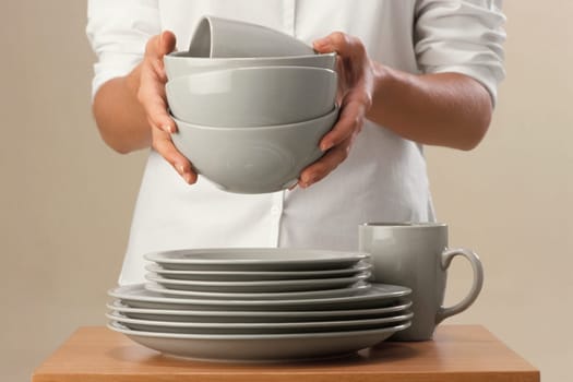 Mid section view of a chef holding bowls
