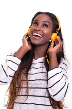 Beautiful young african woman listening to music, isolated over white