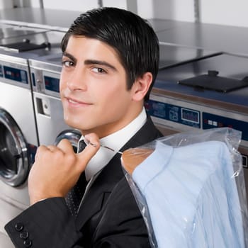 Businessman carrying a hanger in a laundromat