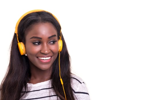 Beautiful young african woman listening to music, isolated over white