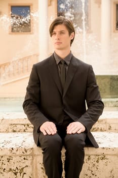 Businessman sitting near a fountain, Biltmore Hotel, Coral Gables, Florida, USA