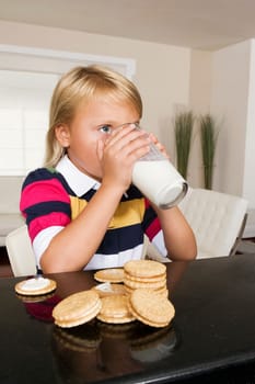 Girl having cookies and milk