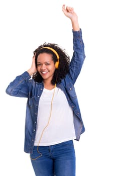 Beautiful young african woman listening to music, isolated over white