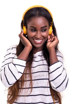 Beautiful young african woman listening to music, isolated over white