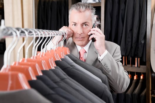 Customer talking on a mobile phone in a clothing store