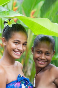 Portrait of two female friends enjoying rain and smiling
