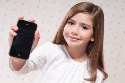Portrait of a girl showing a mobile phone