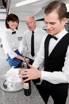 Waiter opening a wine bottle
