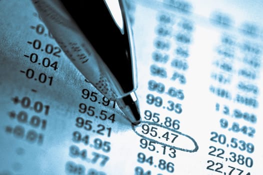 Close_up of a pen marking on a financial data