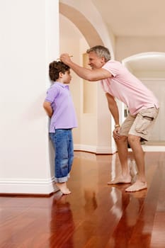 Man measuring his sonŽs height