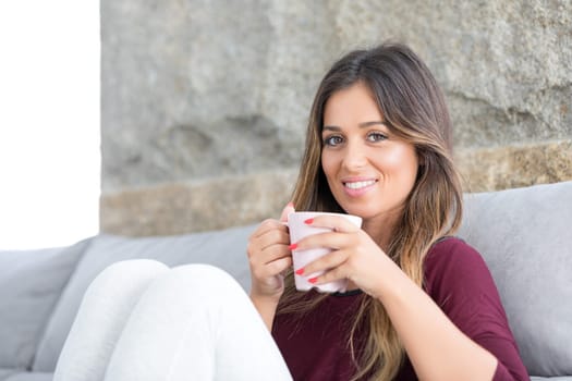 Beautiful young woman relaxing at home