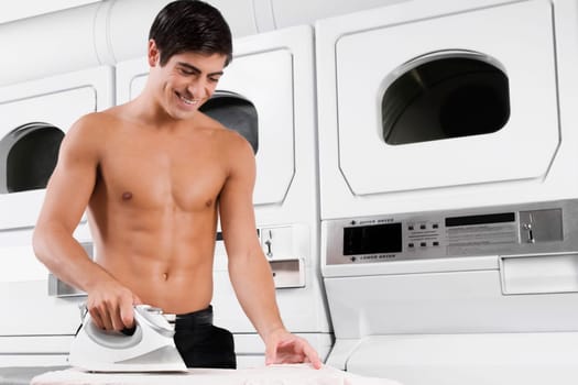 Man ironing a shirt and smiling