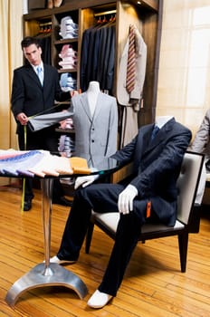 Tailor taking measurement in a clothing store