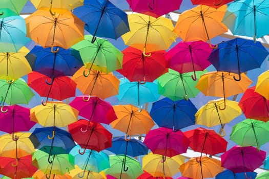 Lots of umbrellas coloring the sky in the city of Agueda, Portugal