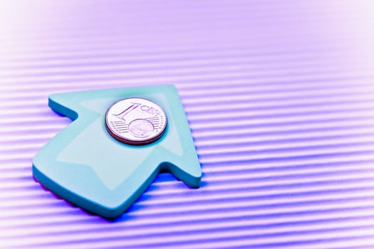 Close_up of one Euro coin on an upward arrow