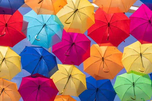 Lots of umbrellas coloring the sky in the city of Agueda, Portugal