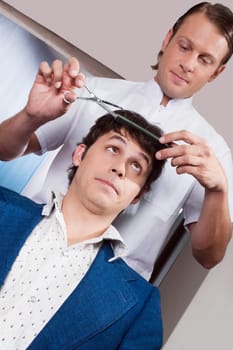 Man receiving a haircut in a salon