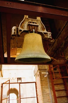 Low angle view of a bell hanging from an iron bar, Toledo, Spain