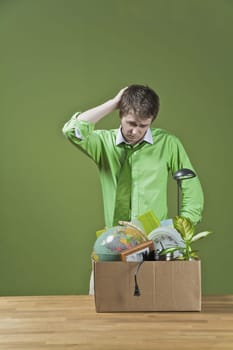 Fired businessman with his office belongings