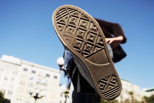 Low angle view of a person showing his shoe