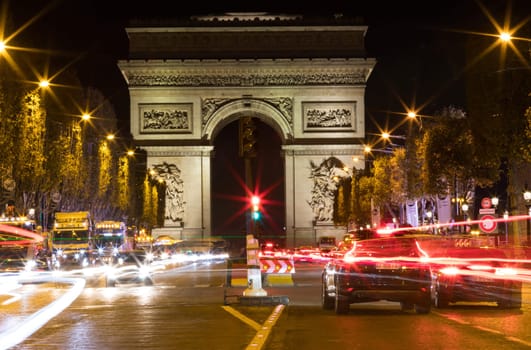 Paris, France - October 8, 2018: The Avenue des Champs Elysees and Arc de Triomphe (Arch of Triumph of the Star) in the autumn at night