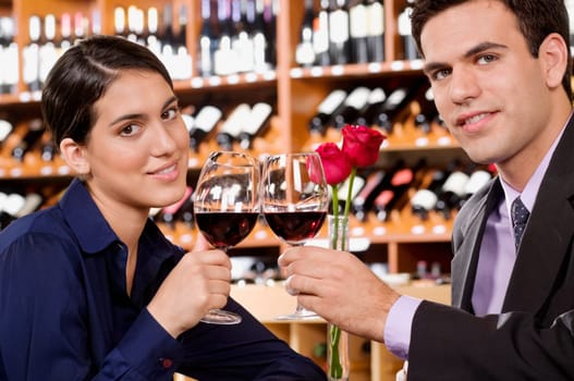 Couple toasting with wine in a bar