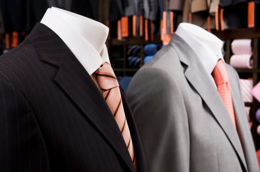 Close_up of mannequins with formal suits in a clothing store