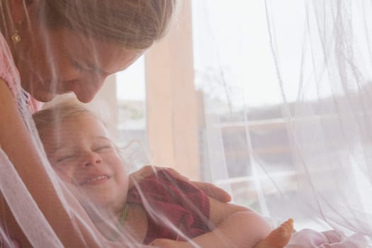 Baby girl sleeping with her mother
