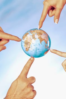Close_up of a businessman and a businesswomanŽs fingers touching a globe