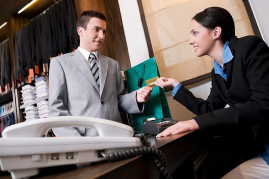 Businessman paying by a credit card in a store