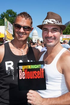 Male homosexual couple standing together and smiling, State Capitol Building, Washington DC, USA