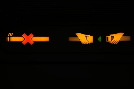Close_up of a No Smoking and Fasten Seatbelt signs