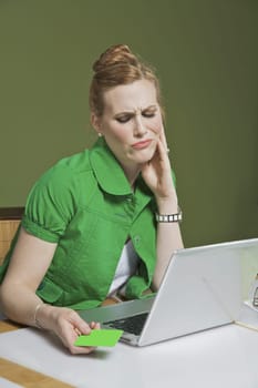 Businesswoman looking at a laptop in the office