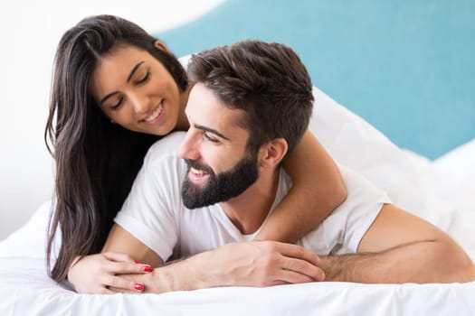 A beautiful young passionate couple in bed