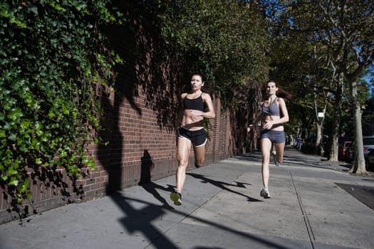 Two women jogging in the street