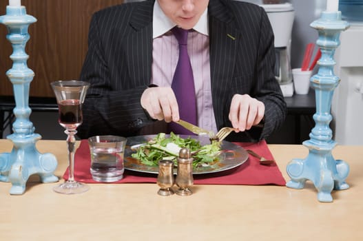 Close_up of a businessman having lunch in the office